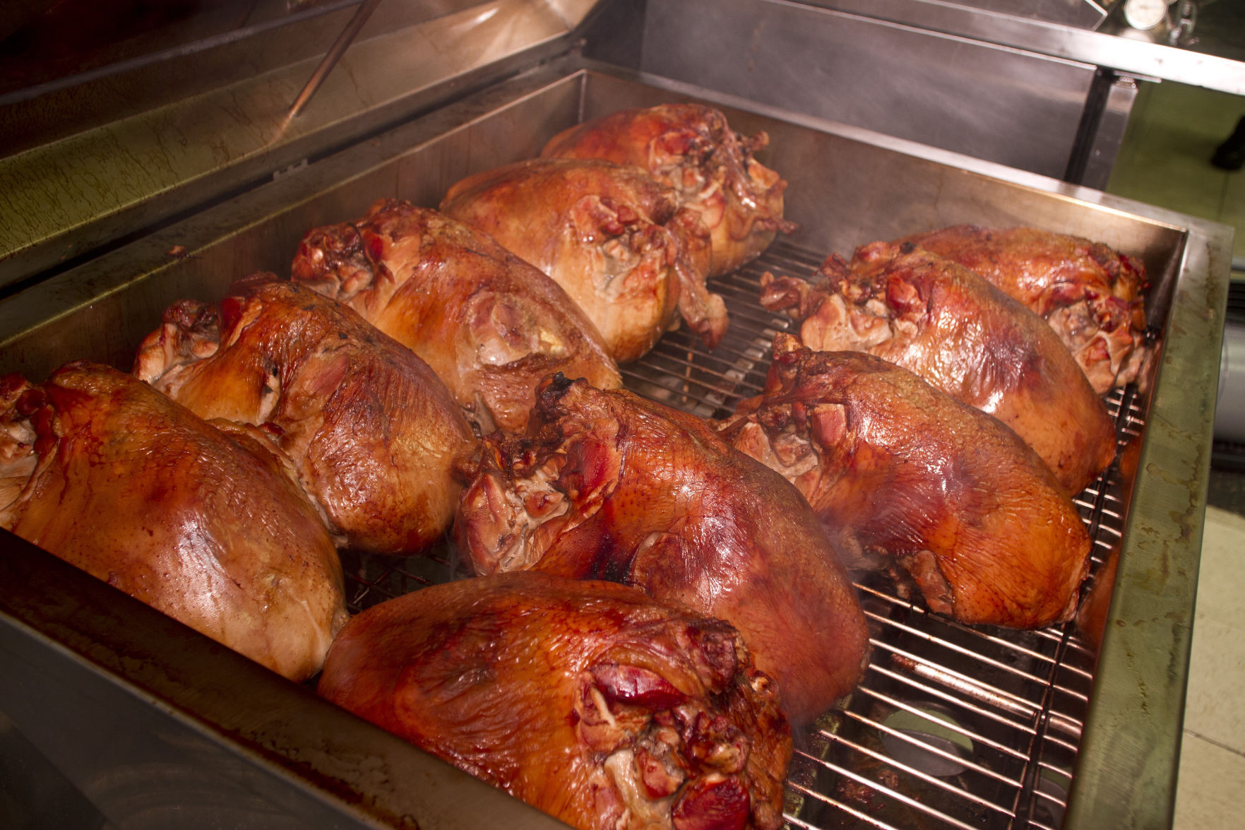 closeup shot of the delicious smoking turkeys